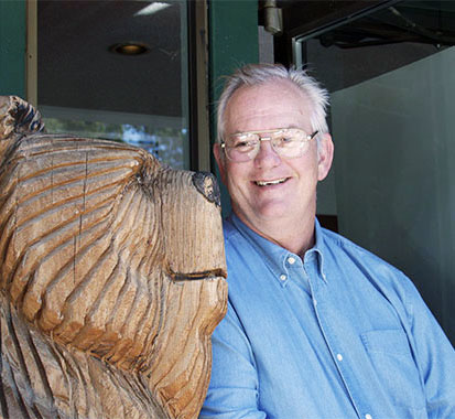 Photo of John with a carved bear statue